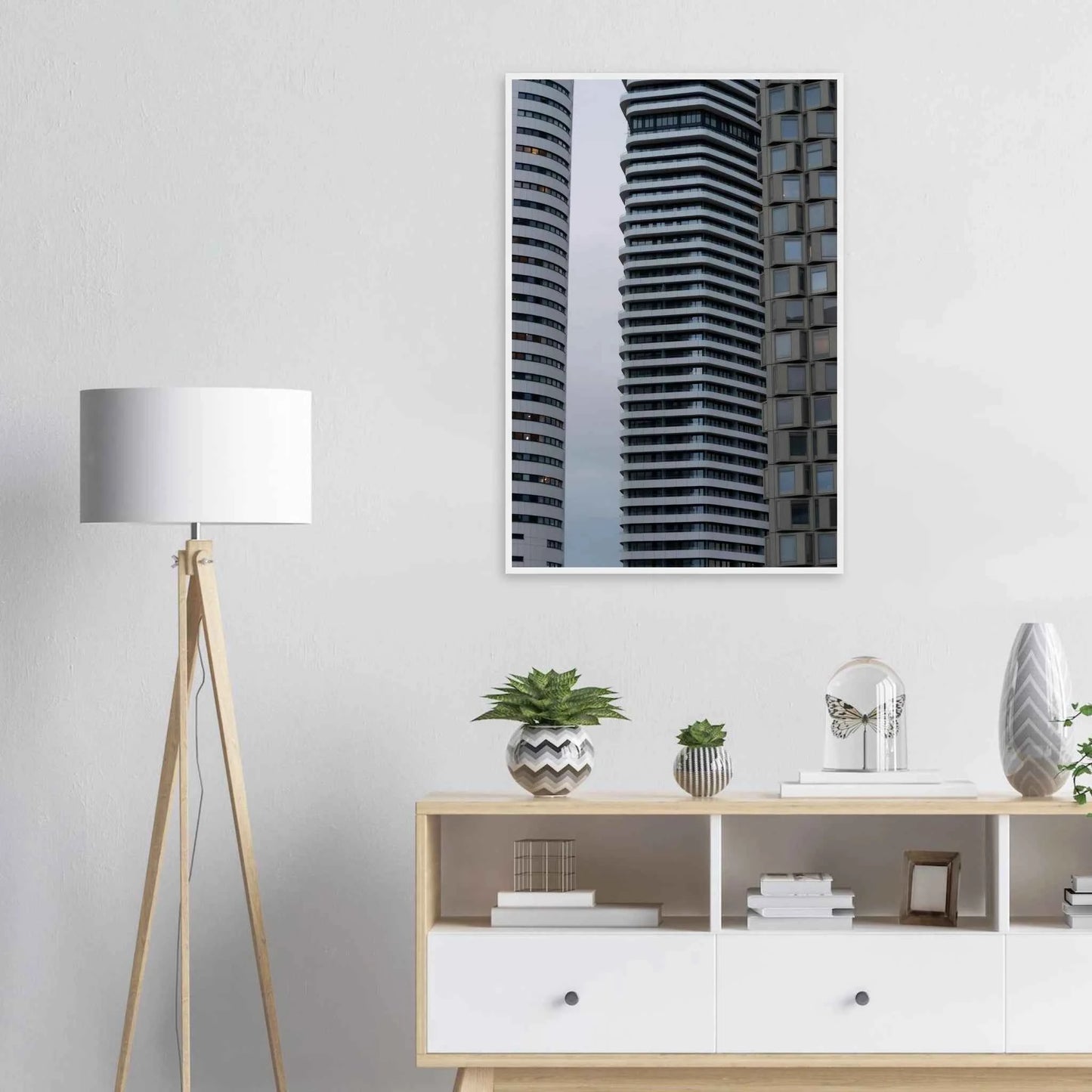 Modern high rise tower buildings with glass and steel facade reaching into the sky on wodden framed wall art on the wall in the Livingroom