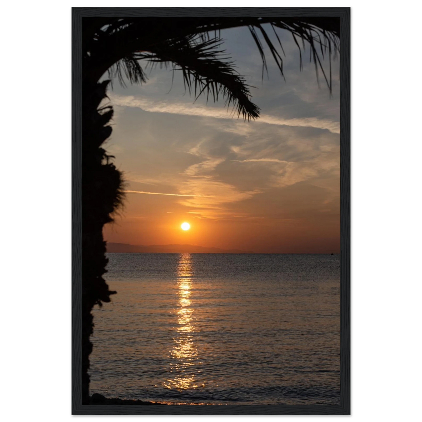Wooden framed wall art Sunset over calm water with golden reflections, framed by tree branches in a peaceful natural landscape