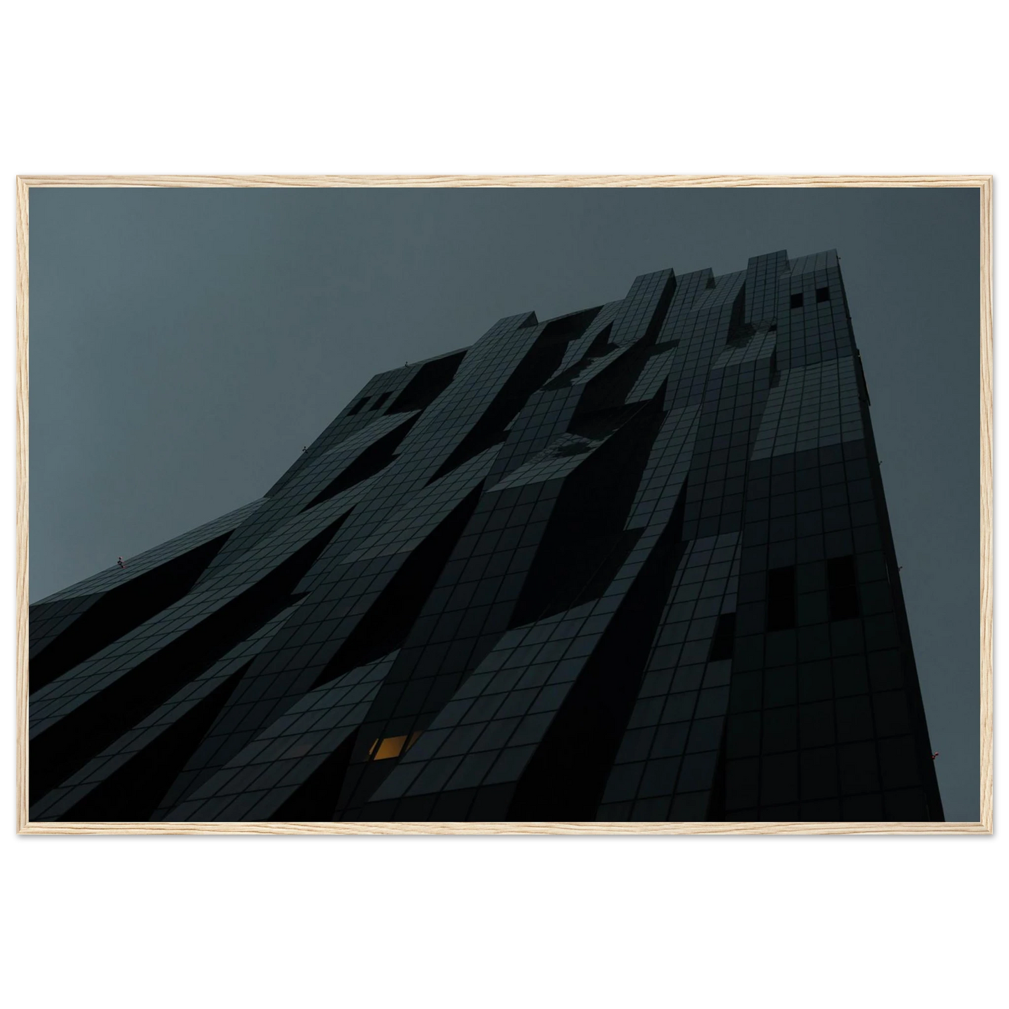 Bluish low angle view of a modern skyscraper with bold geometric lines and dark textured facade on Wooden framed wall art