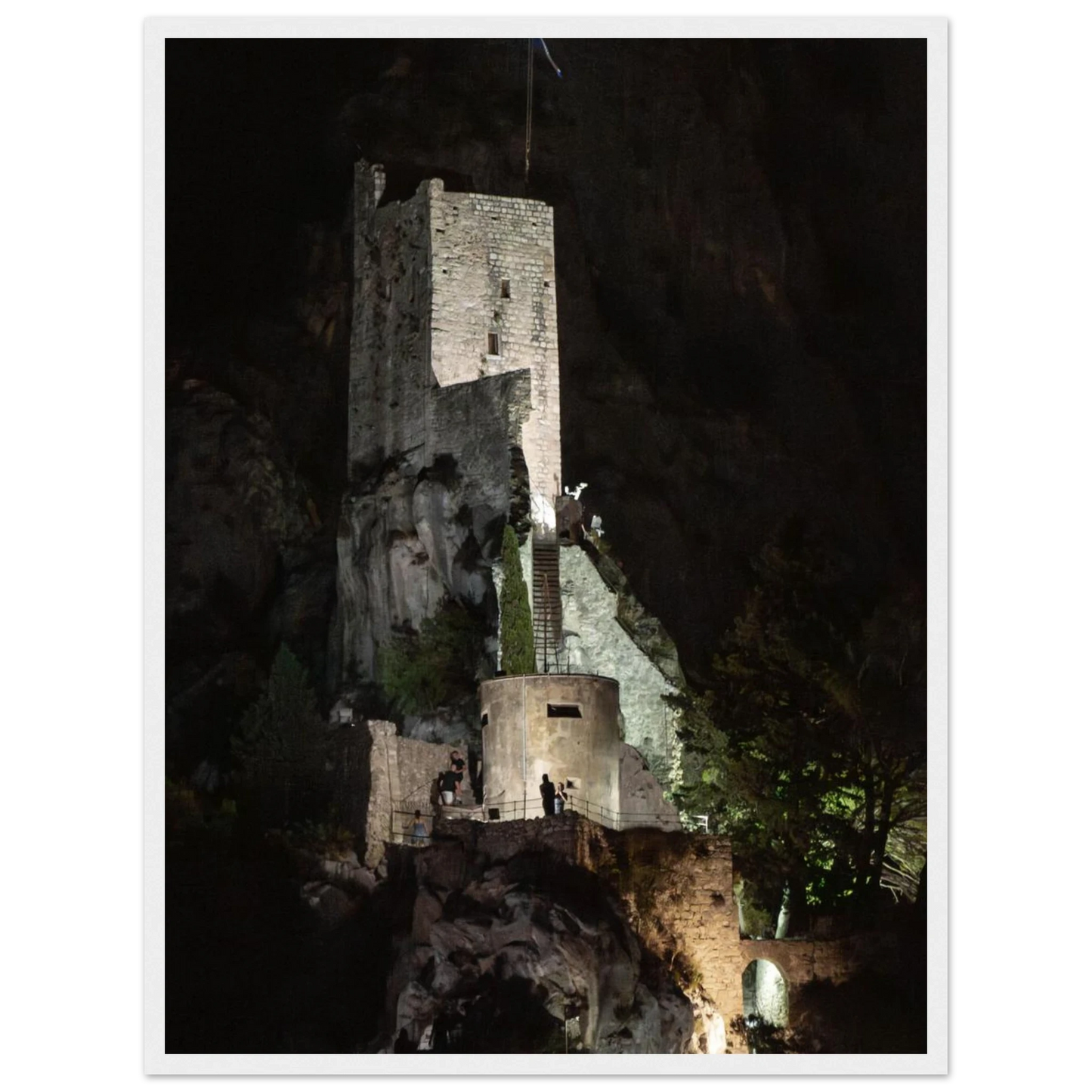 Wooden framed wall art of an ancient stone bastion decorated with green climbing plants against a dark background in Shadow Keep