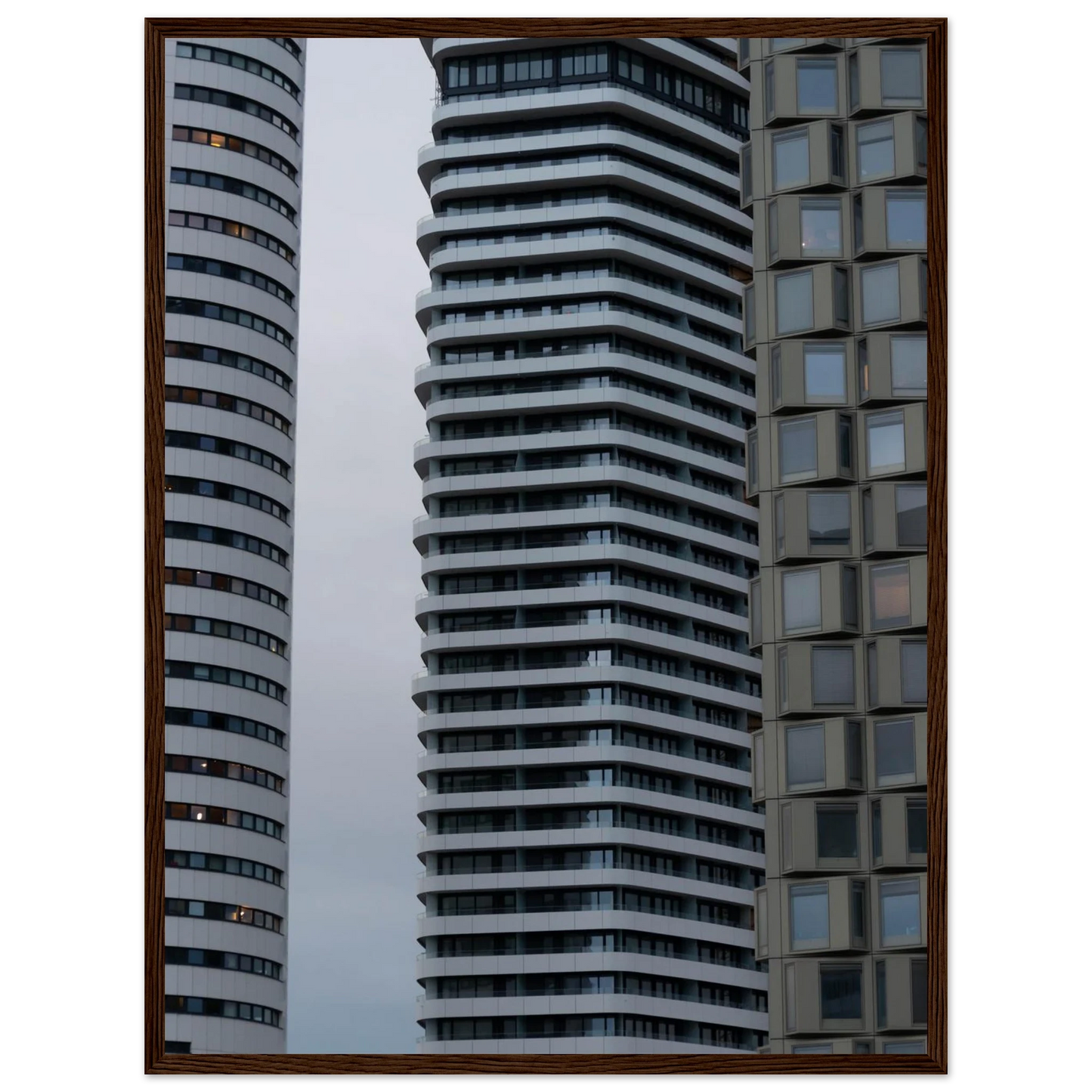 Modern high rise tower buildings with glass and steel facade reaching into the sky on wodden framed wall art