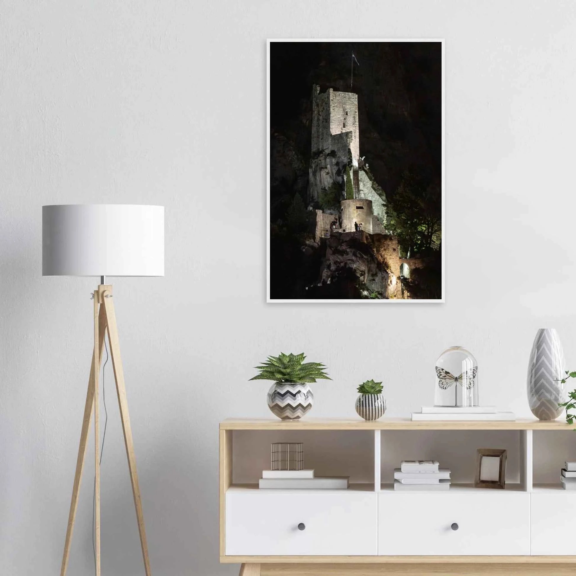 Wooden framed wall art of an ancient stone bastion decorated with green climbing plants against a dark background in Shadow Keep on the wall in the Livingroom