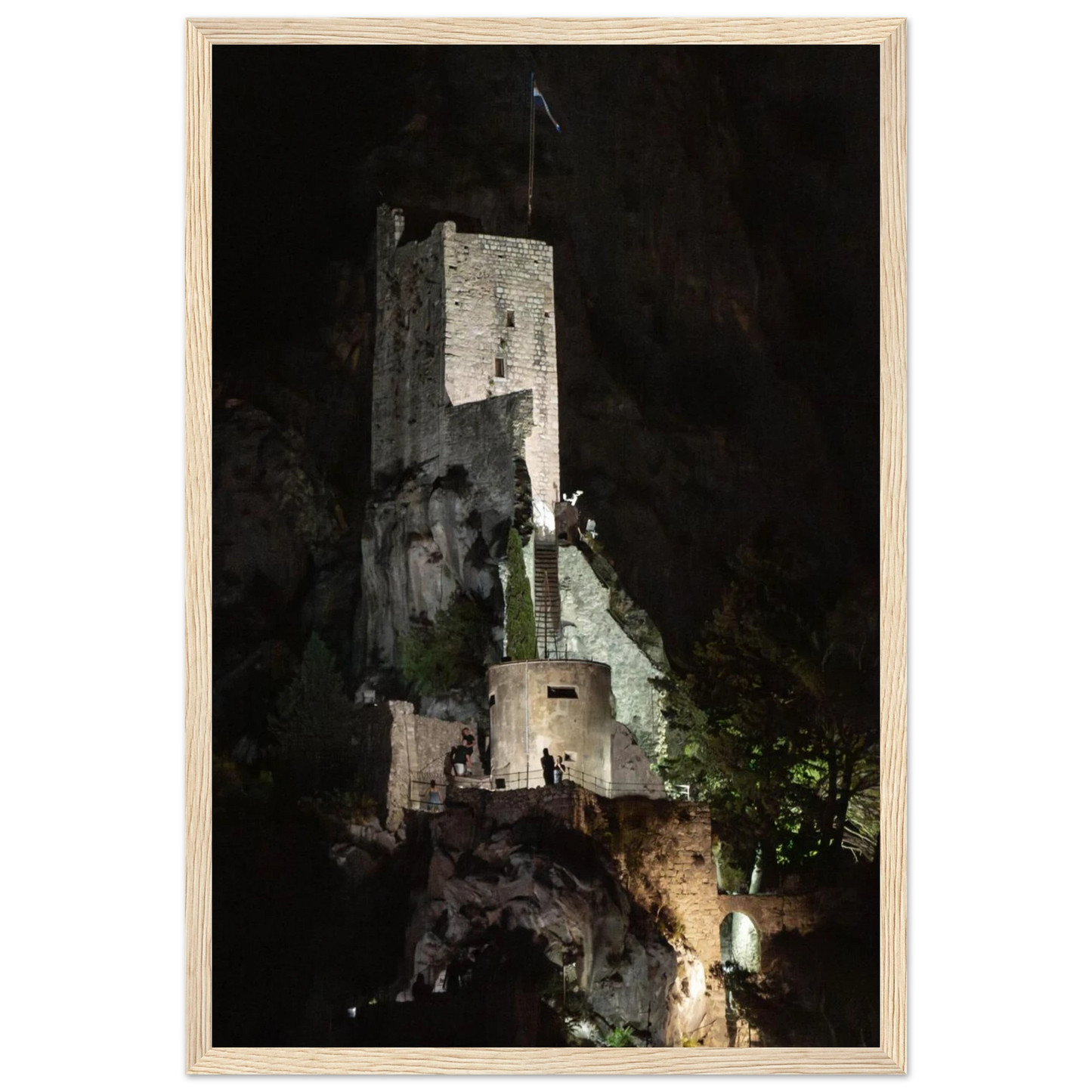 Wooden framed wall art of an ancient stone bastion decorated with green climbing plants against a dark background in Shadow Keep