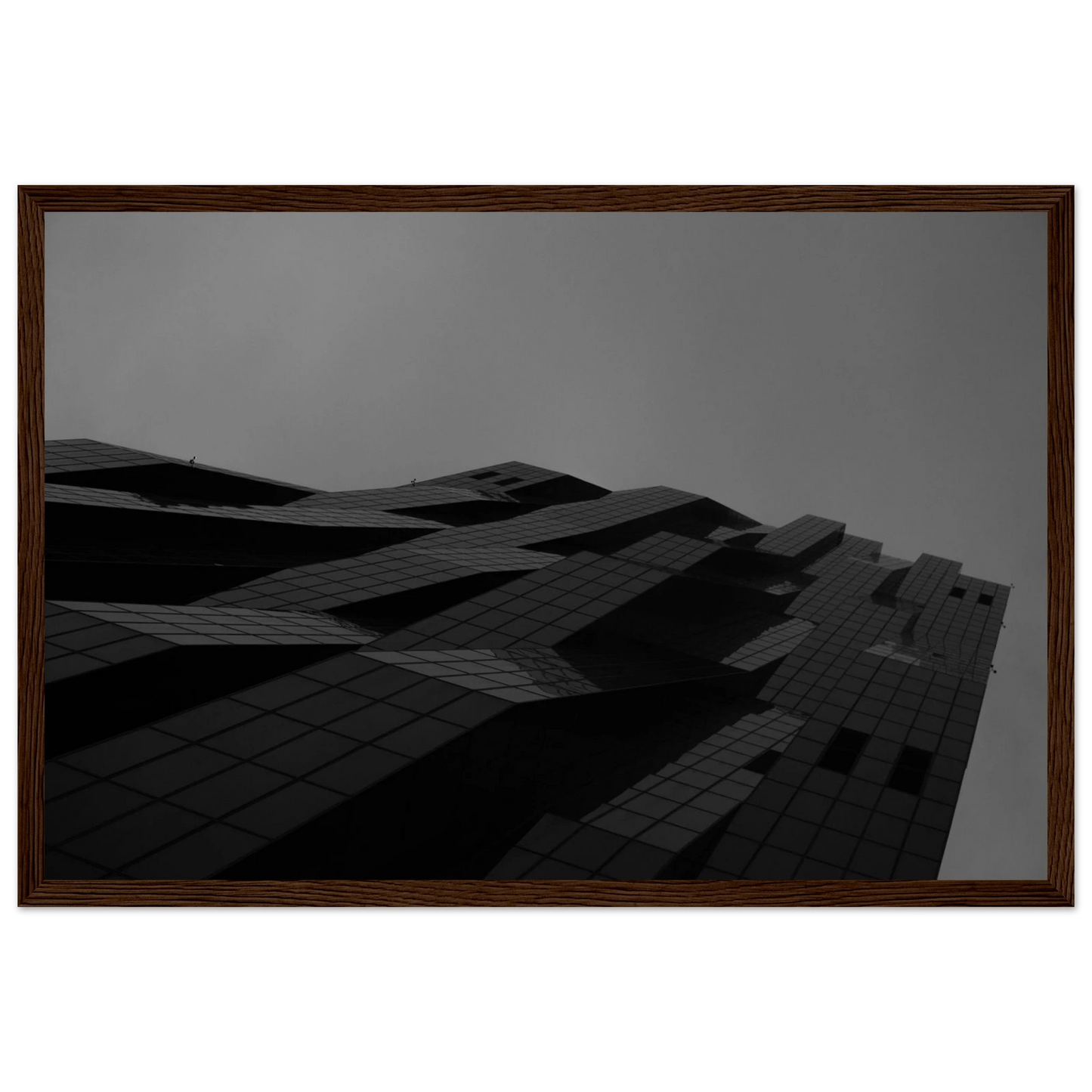 Black and white low angle view of a modern skyscraper with bold geometric lines and dark textured facade on wooden framed wall art
