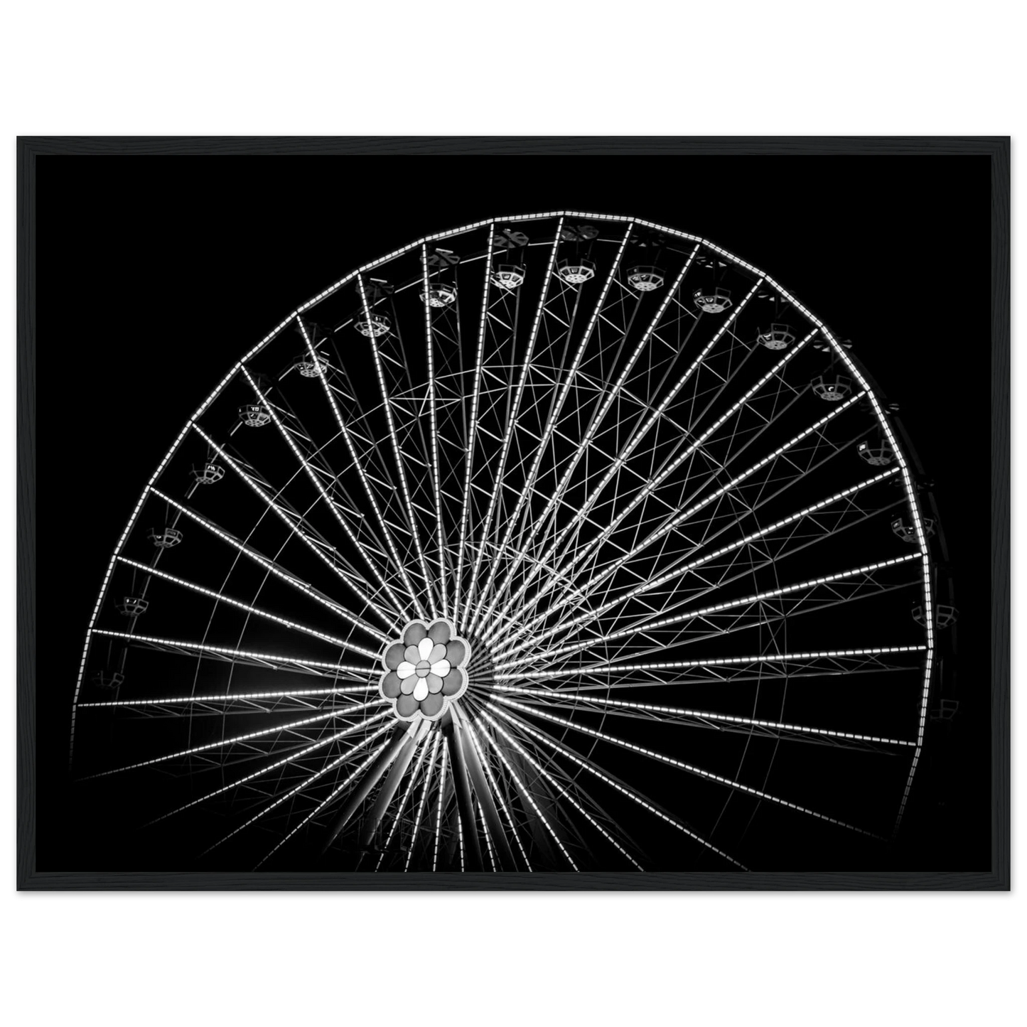 Black and white night photo of the Vienna Prater Giant Ferris Wheel (Wiener Riesenrad) with illuminated spokes forming a circular pattern against the dark sky on wooden framed wall art