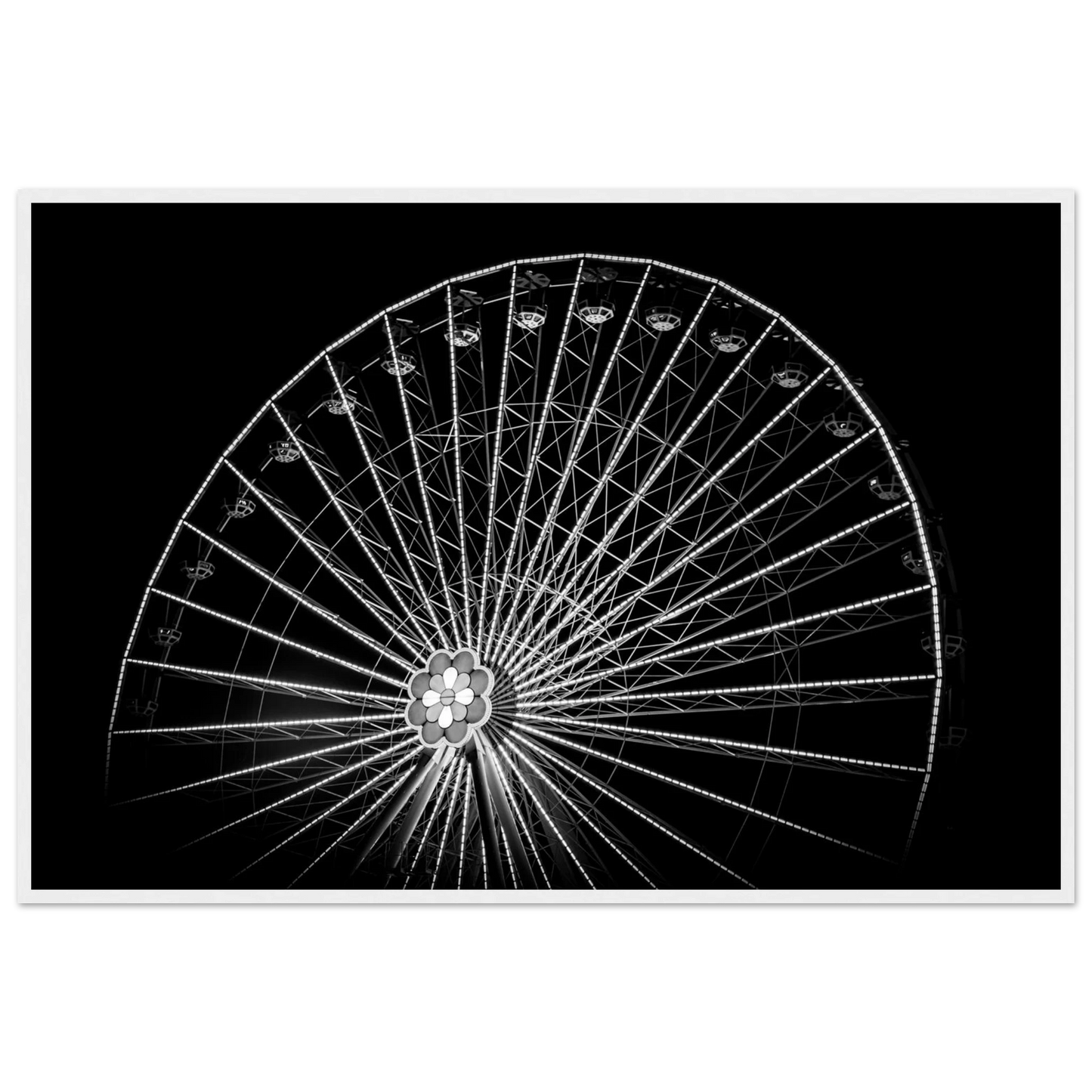 Black and white night photo of the Vienna Prater Giant Ferris Wheel (Wiener Riesenrad) with illuminated spokes forming a circular pattern against the dark sky on wooden framed wall art