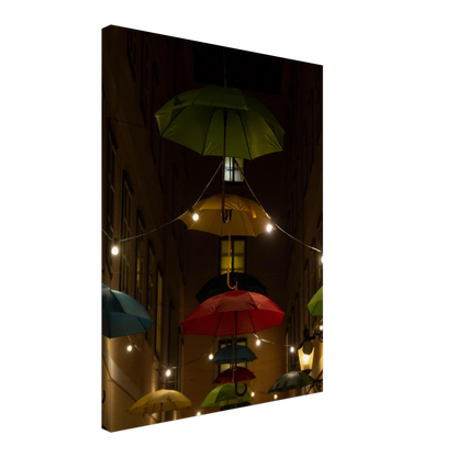 Nighttime street scene with colorful illuminated umbrellas hanging as decoration above a vibrant outdoor area on a Canvas print
