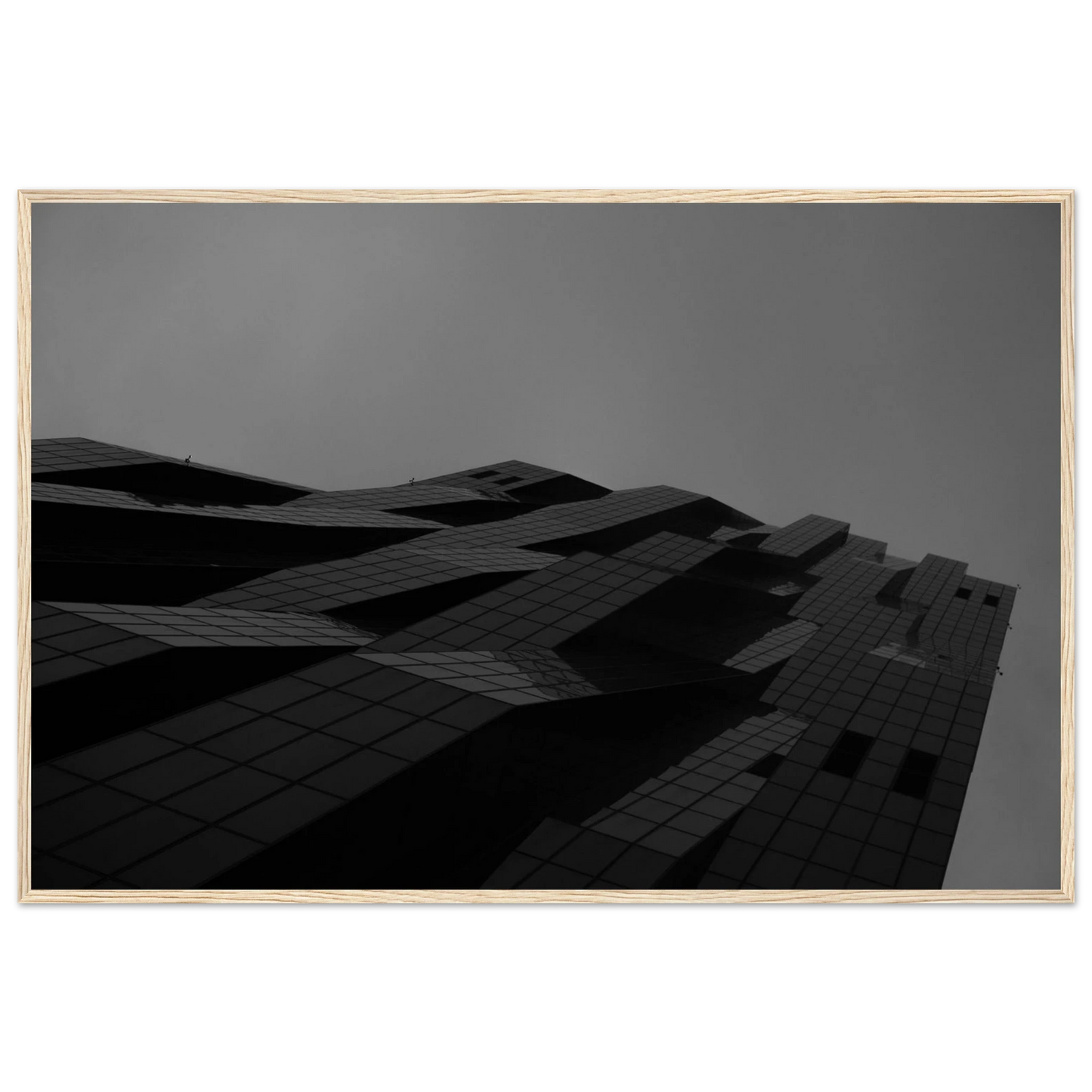 Black and white low angle view of a modern skyscraper with bold geometric lines and dark textured facade on wooden framed wall art