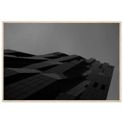 Black and white low angle view of a modern skyscraper with bold geometric lines and dark textured facade on wooden framed wall art