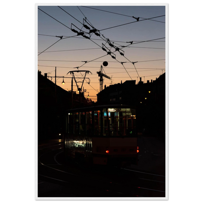Wooden framed wall art featuring a tram the Nightline driving between houses under power lines during a golden sunset