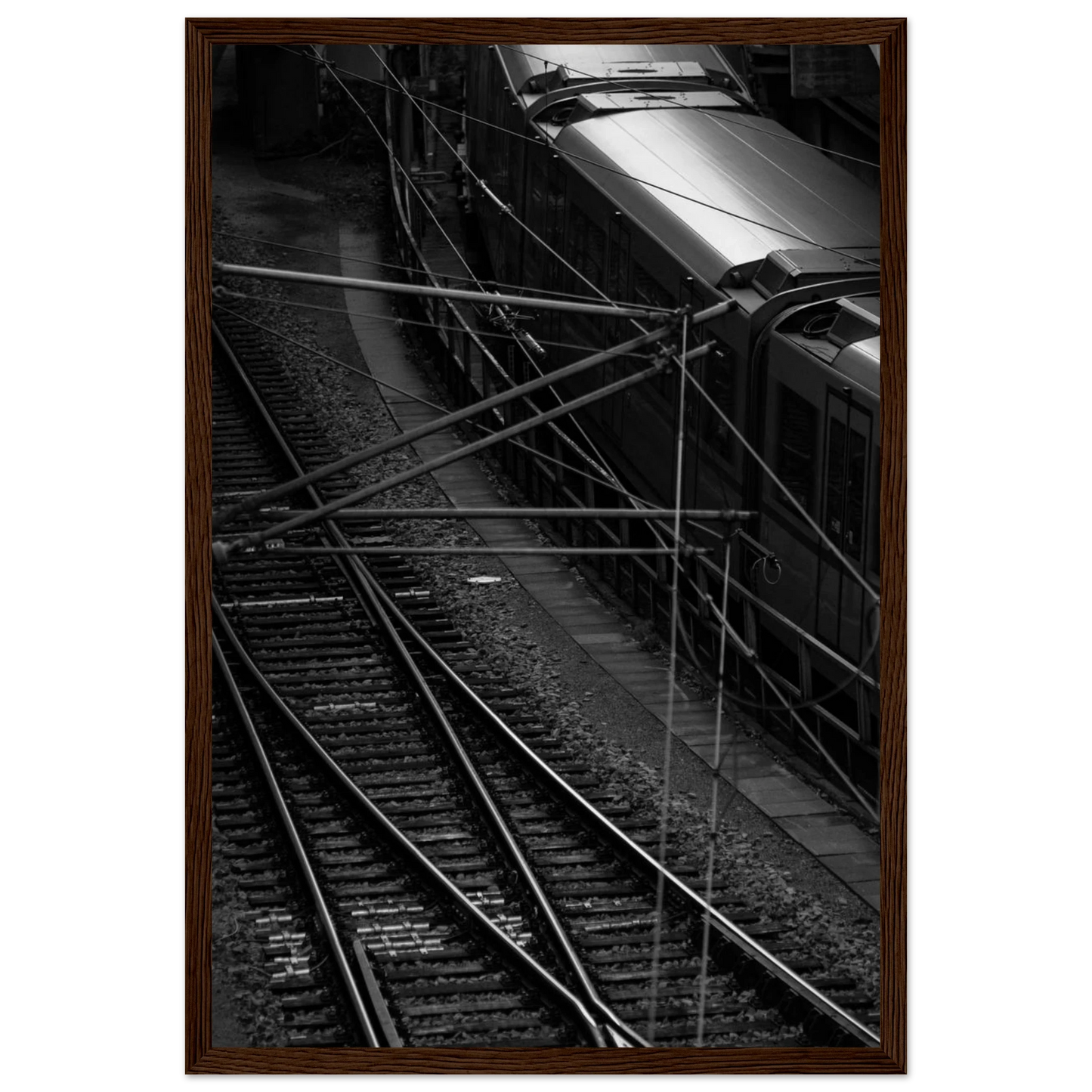 Black and white aerial view of metro train and railway tracks in an urban underground or elevated rail system on wooden framed wall art
