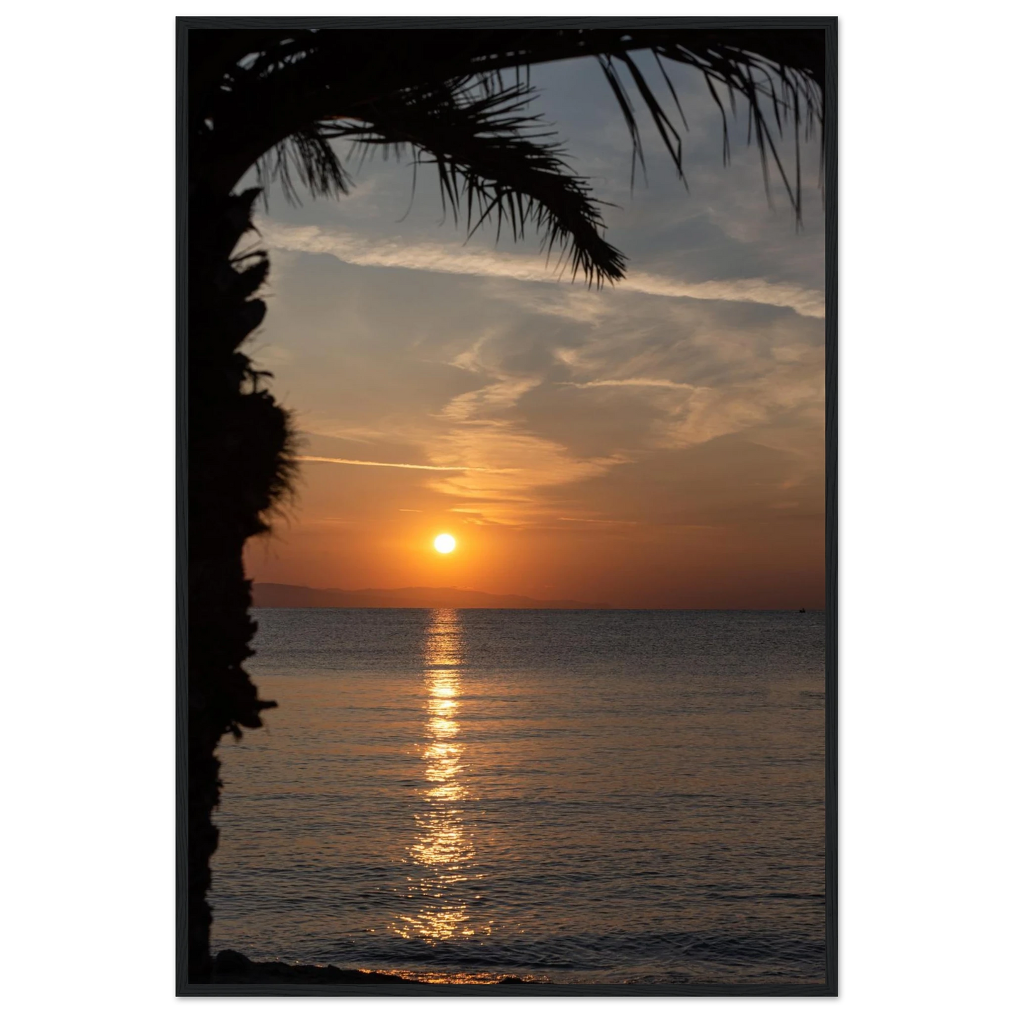Wooden framed wall art Sunset over calm water with golden reflections, framed by tree branches in a peaceful natural landscape