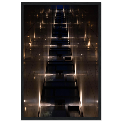 Low angle view looking up a narrow corridor-like passage between two skyscraper walls lined with rows of windows stretching toward the sky on wooden framed wall art