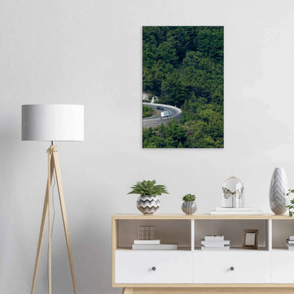 Aerial view of a winding road curve with cars surrounded by lush green forest landscape on Canvas print wall art on the wall in the Livingroom