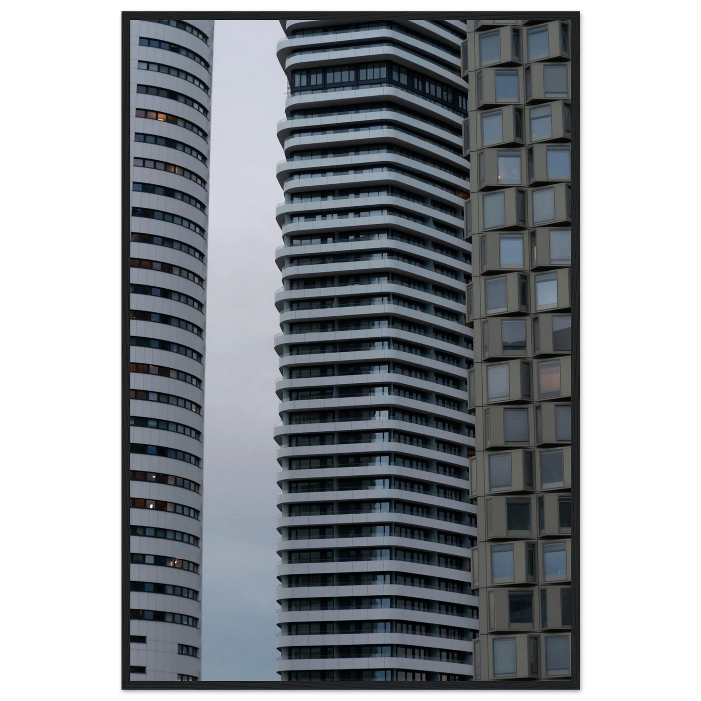 Modern high rise tower buildings with glass and steel facade reaching into the sky on wodden framed wall art
