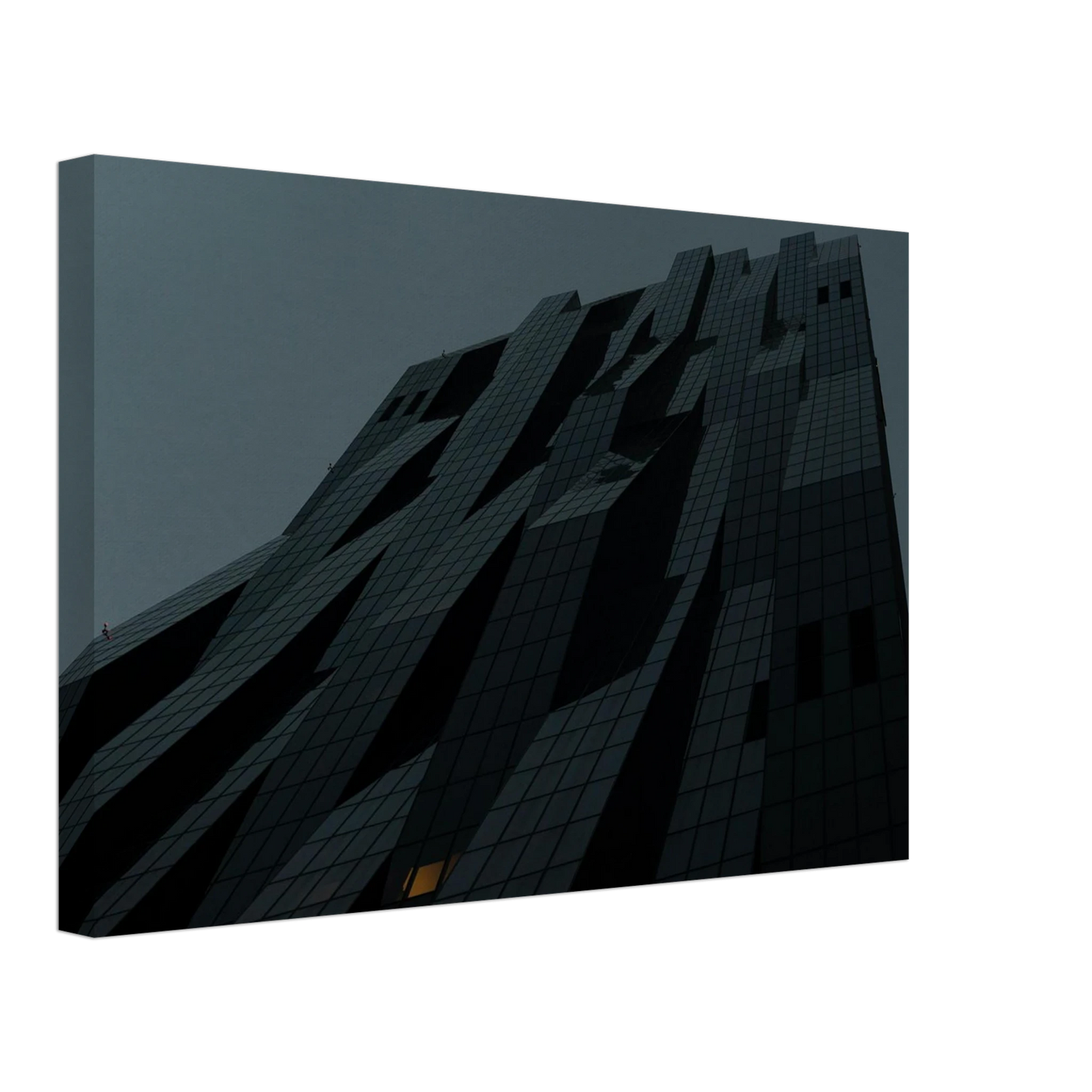 Bluish low angle view of a modern skyscraper with bold geometric lines and dark textured facade on Canvas Print wall art