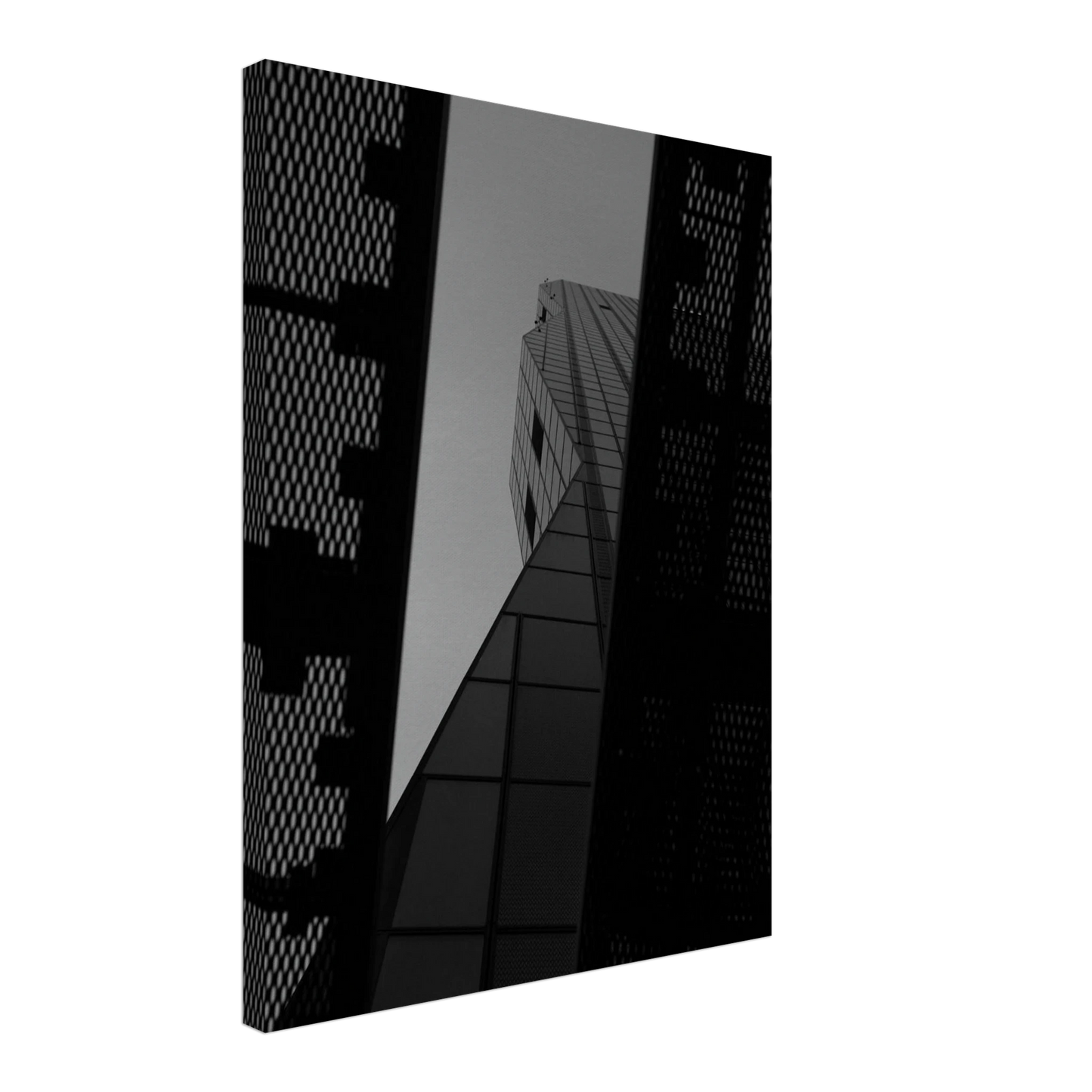 Black and white Low angle view looking up at a tall glass skyscraper framed between two metal structural elements on Canvas Print wall art