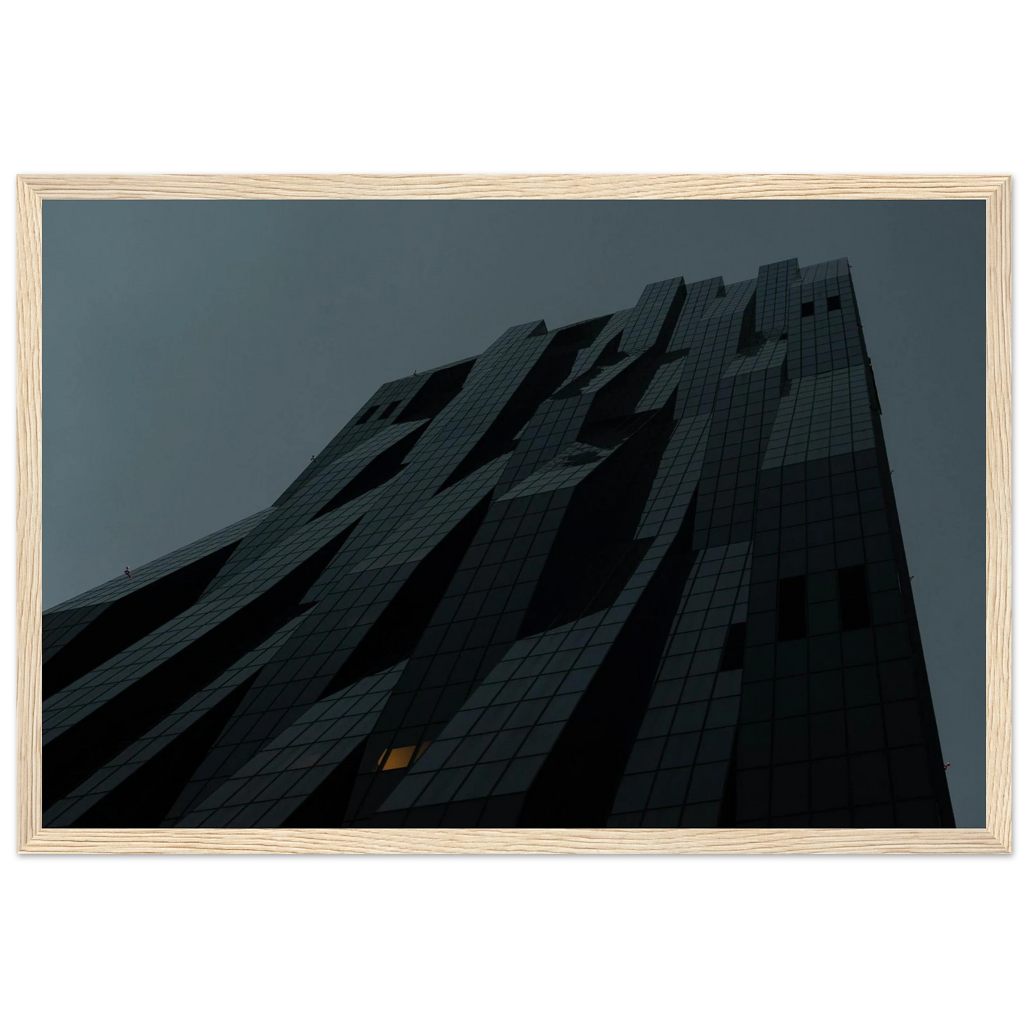 Bluish low angle view of a modern skyscraper with bold geometric lines and dark textured facade on Wooden framed wall art