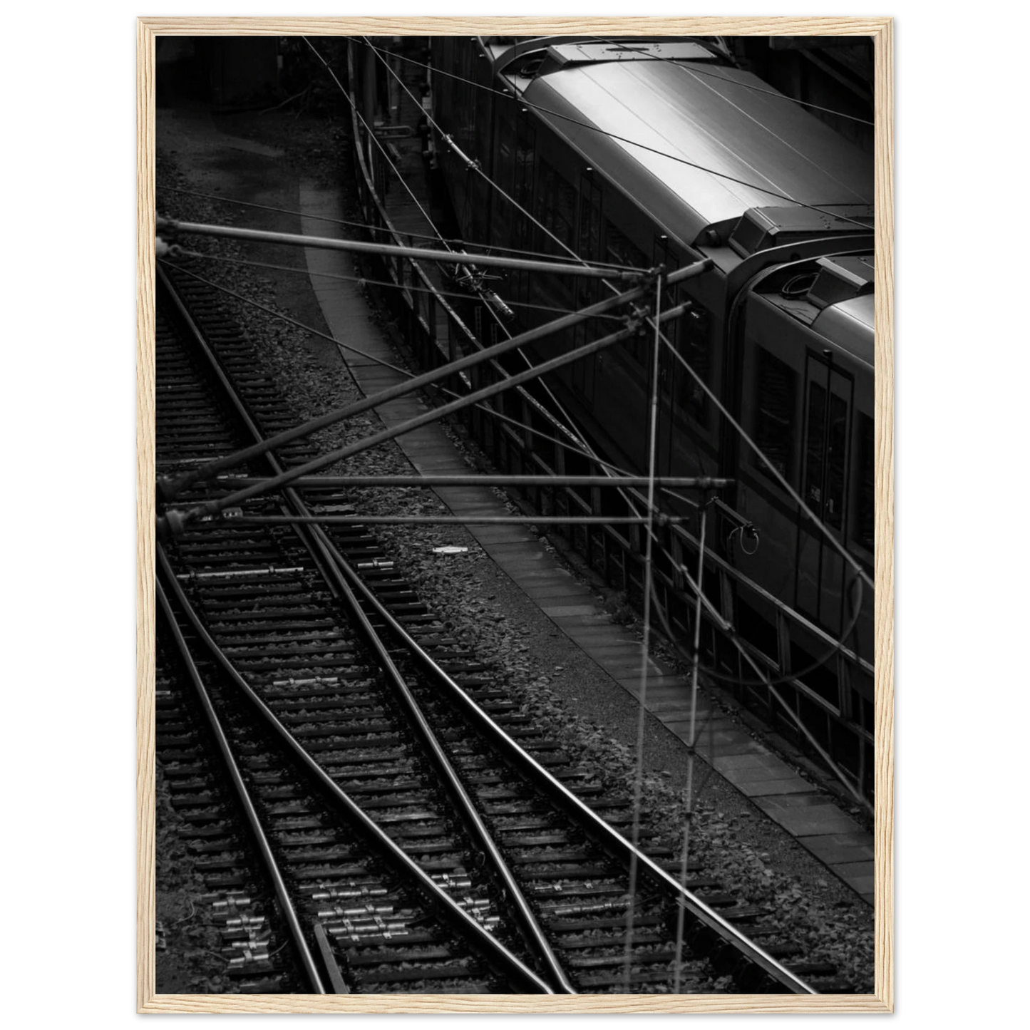 Black and white aerial view of metro train and railway tracks in an urban underground or elevated rail system on wooden framed wall art