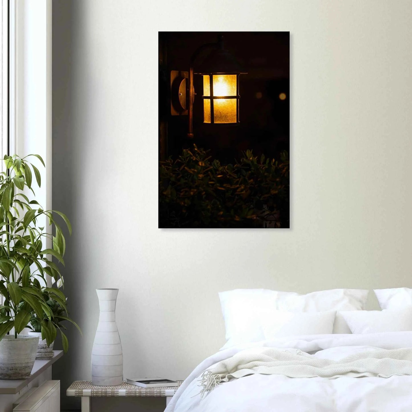 Glowing vintage lantern mounted on a wooden pole in front of a bush at night on Canvas Print wall art on the wall in the Bedroom