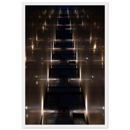 Low angle view looking up a narrow corridor-like passage between two skyscraper walls lined with rows of windows stretching toward the sky on wooden framed wall art