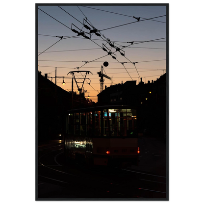 Wooden framed wall art featuring a tram the Nightline driving between houses under power lines during a golden sunset