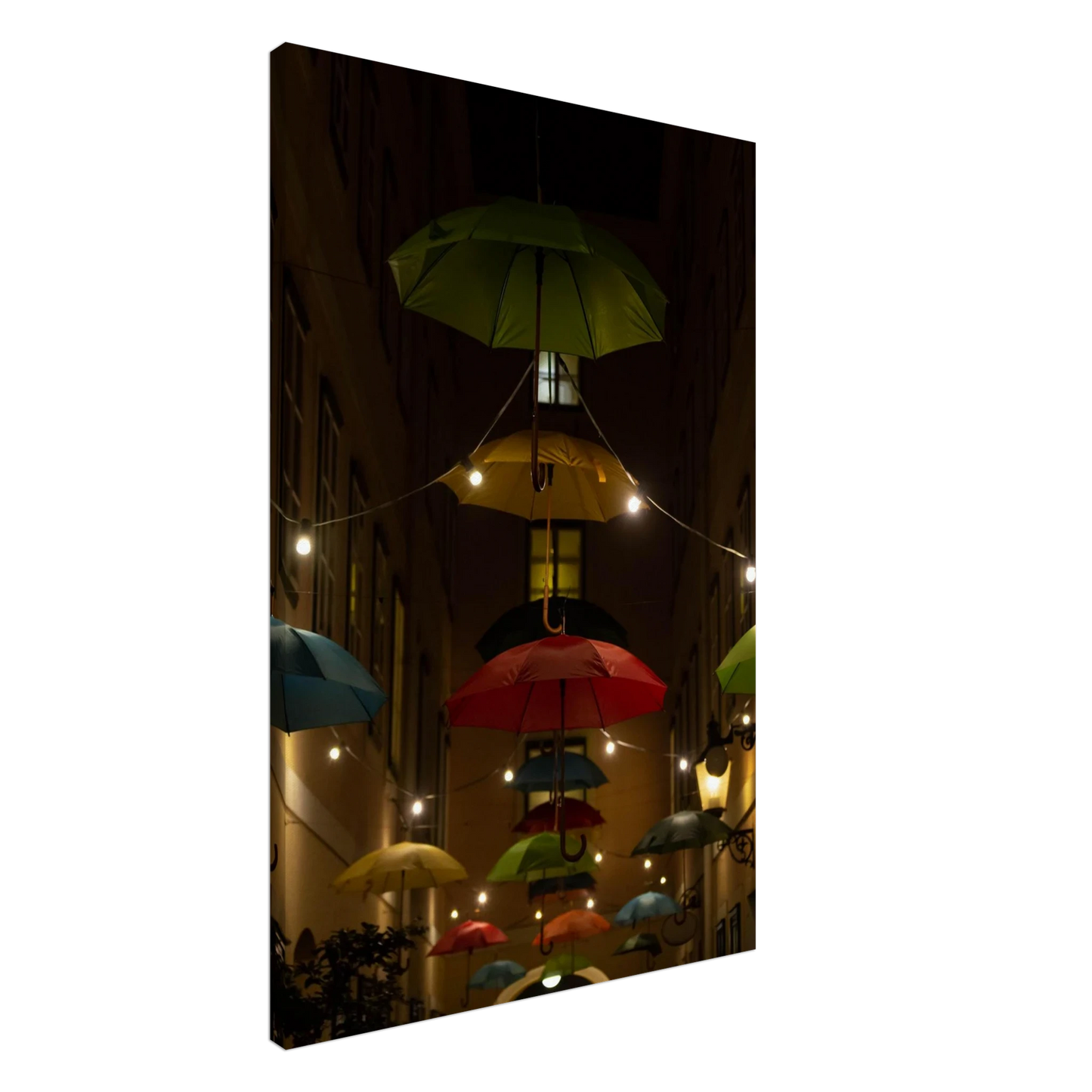 Nighttime street scene with colorful illuminated umbrellas hanging as decoration above a vibrant outdoor area on a Canvas print
