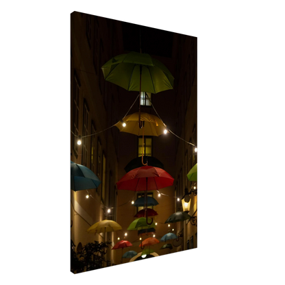 Nighttime street scene with colorful illuminated umbrellas hanging as decoration above a vibrant outdoor area on a Canvas print