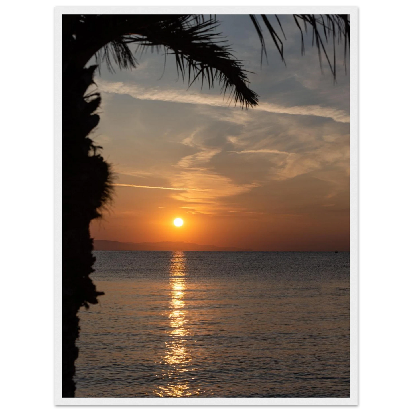 Wooden framed wall art Sunset over calm water with golden reflections, framed by tree branches in a peaceful natural landscape