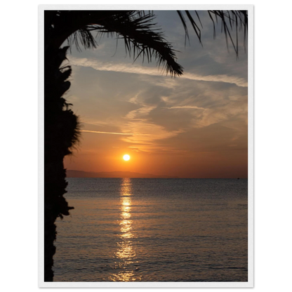 Wooden framed wall art Sunset over calm water with golden reflections, framed by tree branches in a peaceful natural landscape