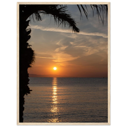 Wooden framed wall art Sunset over calm water with golden reflections, framed by tree branches in a peaceful natural landscape