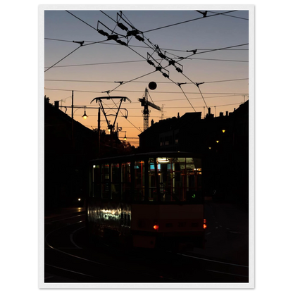 Wooden framed wall art featuring a tram the Nightline driving between houses under power lines during a golden sunset