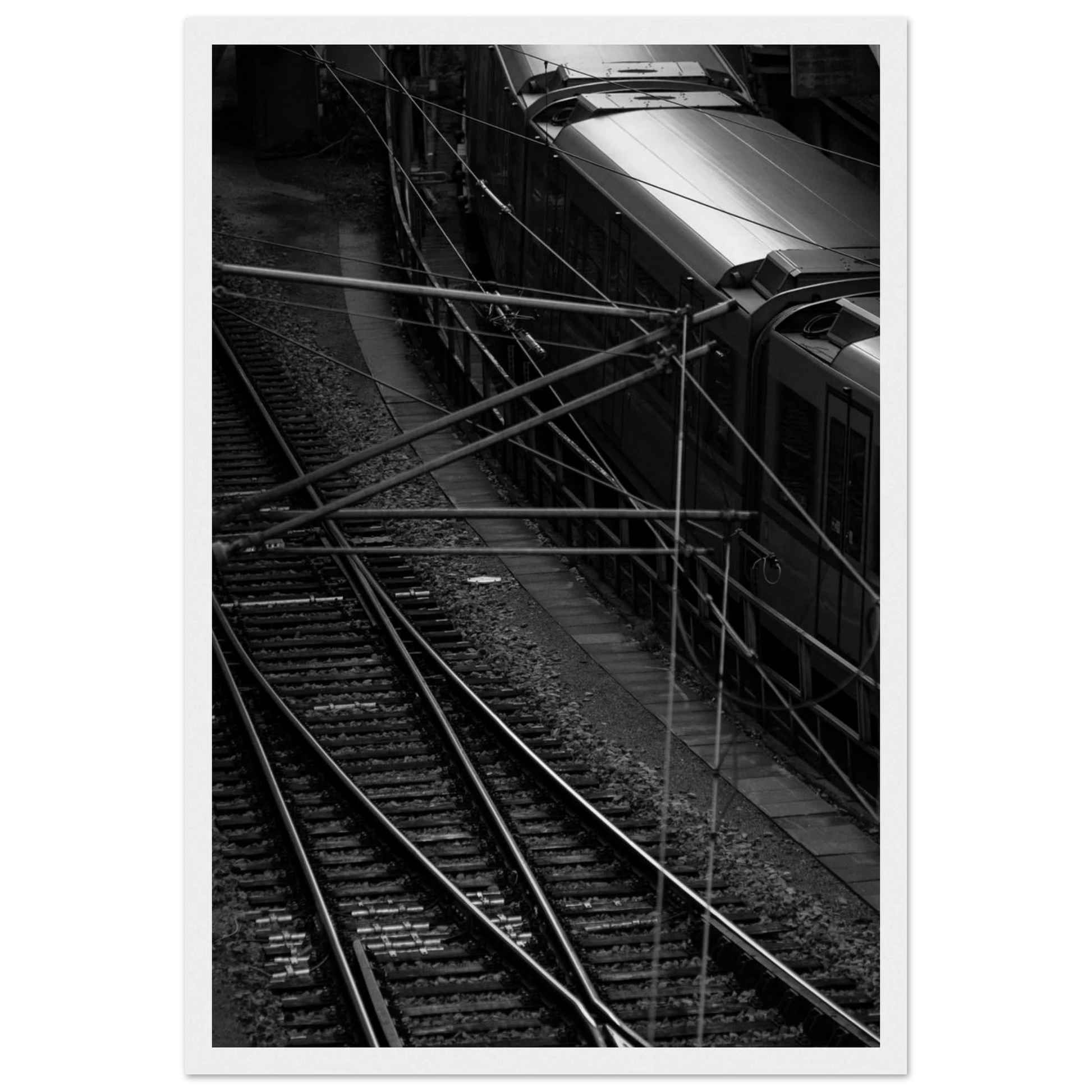 Black and white aerial view of metro train and railway tracks in an urban underground or elevated rail system on wooden framed wall art