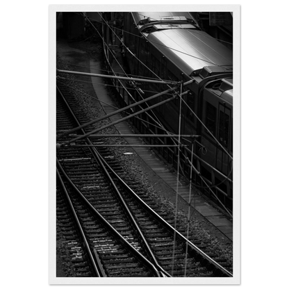 Black and white aerial view of metro train and railway tracks in an urban underground or elevated rail system on wooden framed wall art