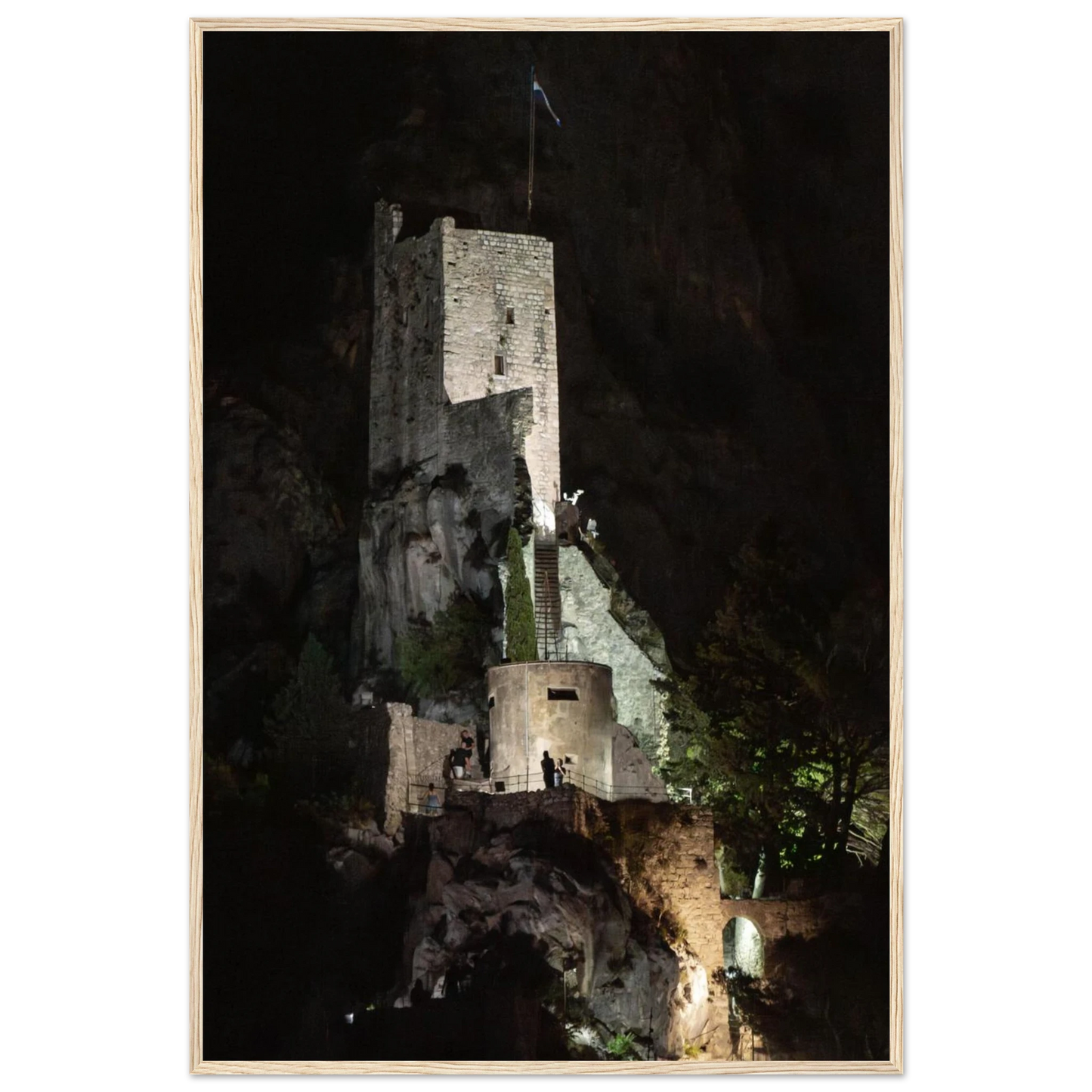 Wooden framed wall art of an ancient stone bastion decorated with green climbing plants against a dark background in Shadow Keep
