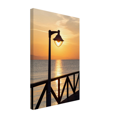 Canvas print wall art of a sunset over the sea with a street lamp on the pier