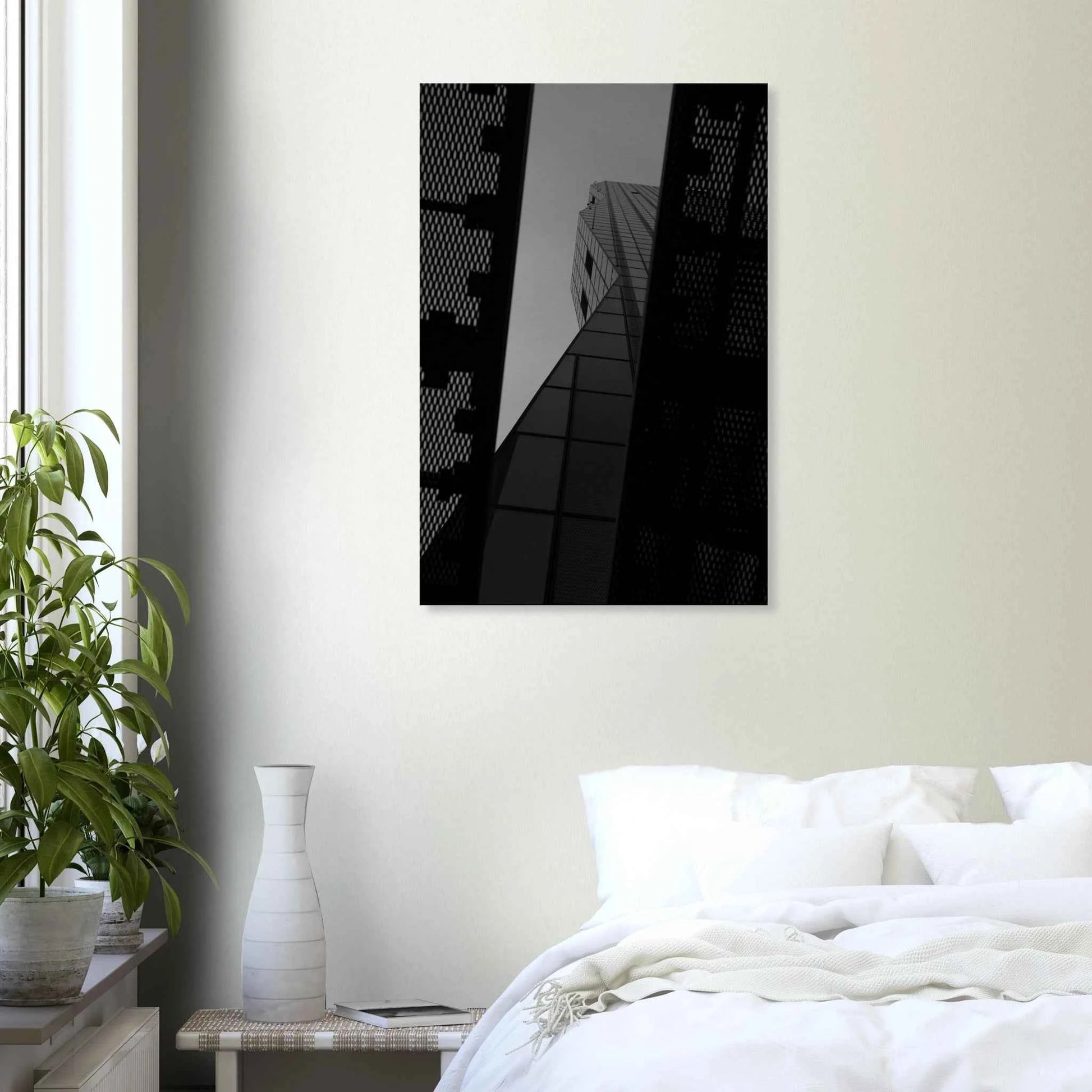Black and white Low angle view looking up at a tall glass skyscraper framed between two metal structural elements on Canvas Print wall art on the wall in the Bedroom
