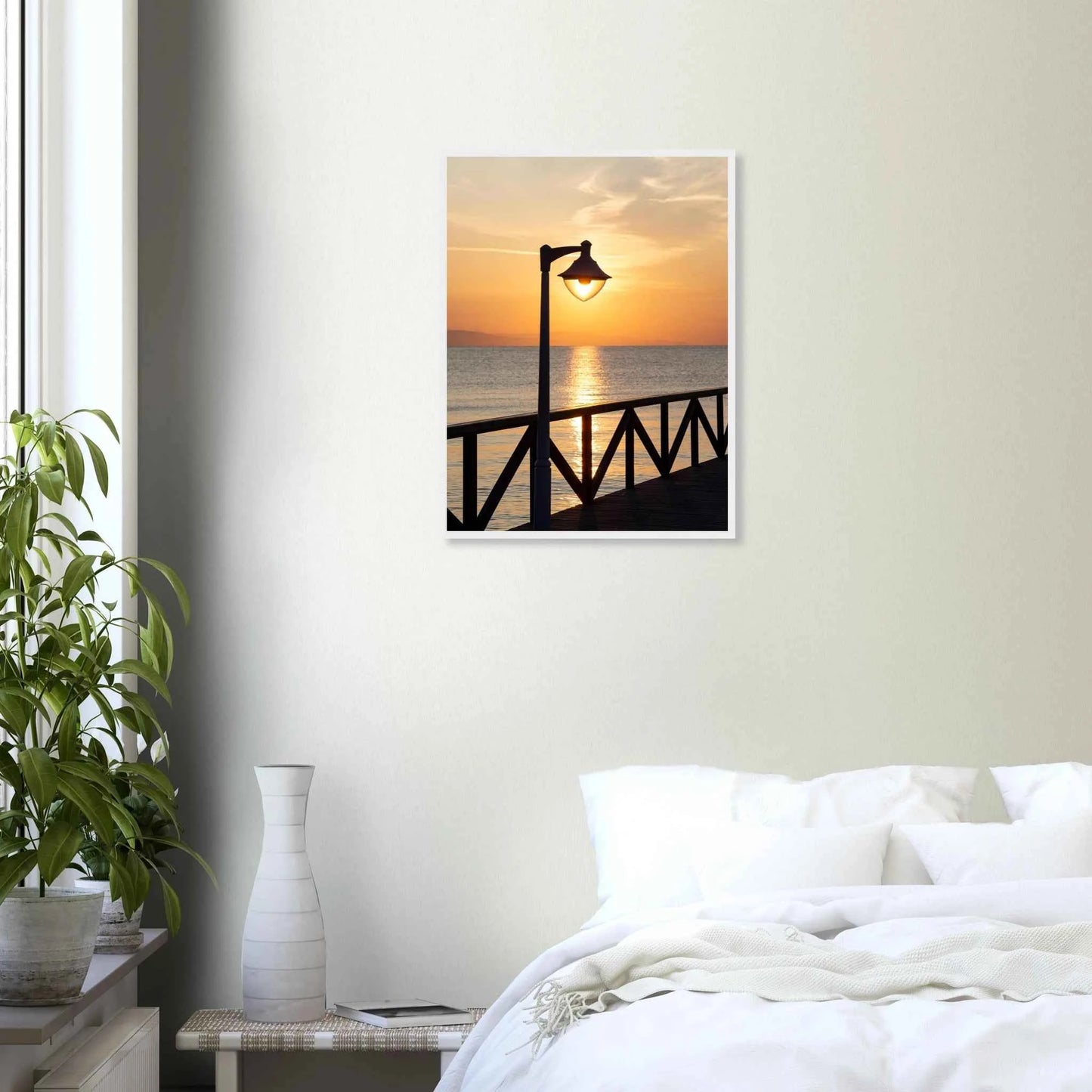 Wooden framed wall art of a sunset over the sea with a street lamp on the pier on the wall in the Bedroom
