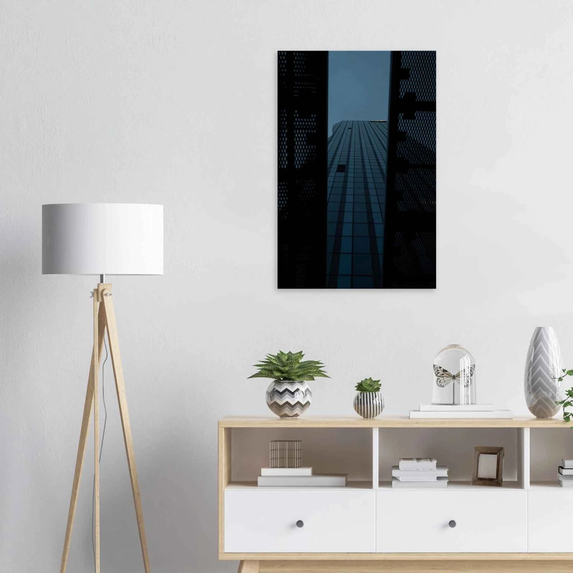 Low angle view looking up at a tall glass skyscraper framed between two metal structural elements on Canvas Print wall art on the wall in the Livingroom