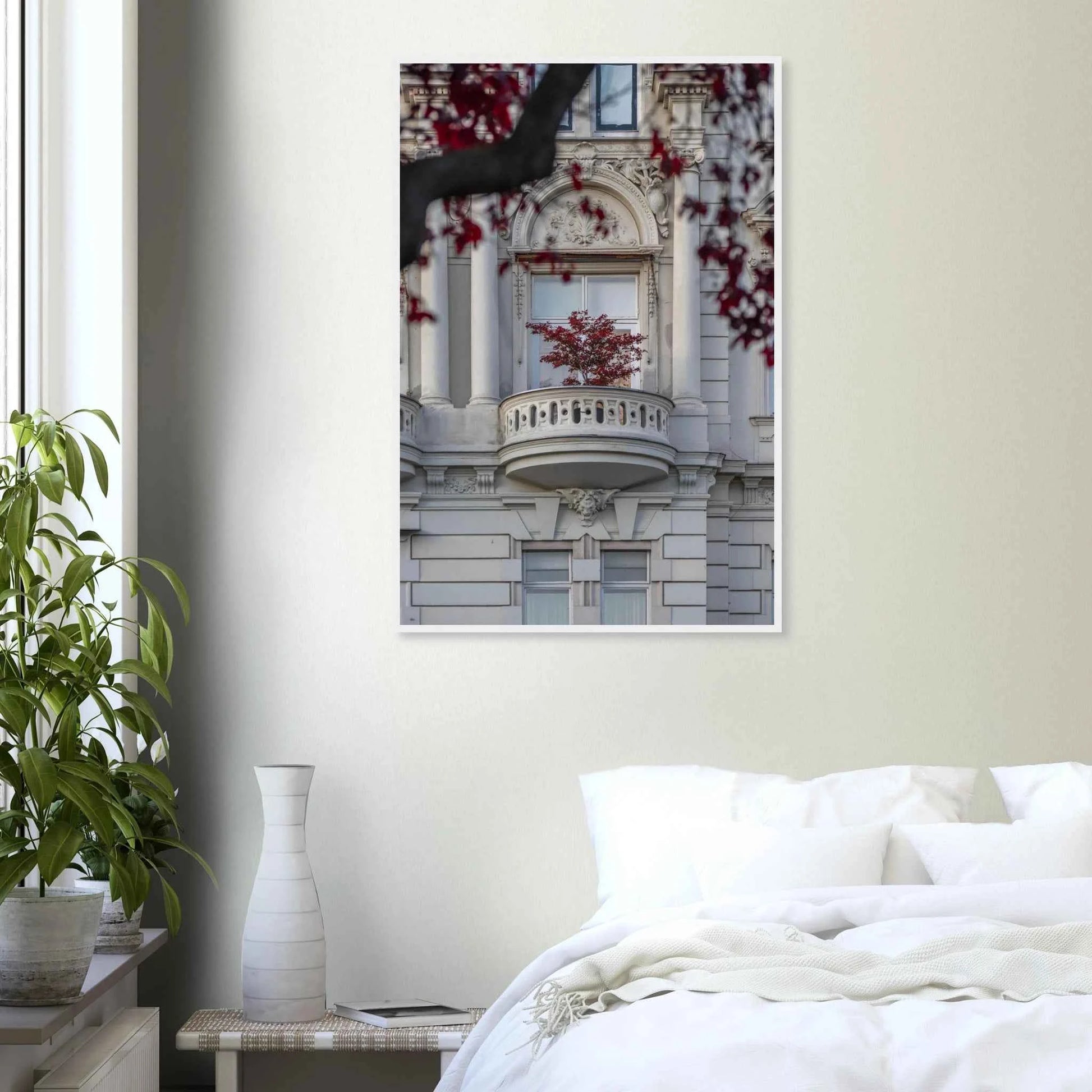 Red leaved tree in autumn colors in front of a historic stone building facade on wooden framed wall art on the wall in the Bedroom
