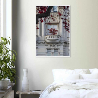 Red leaved tree in autumn colors in front of a historic stone building facade on wooden framed wall art on the wall in the Bedroom