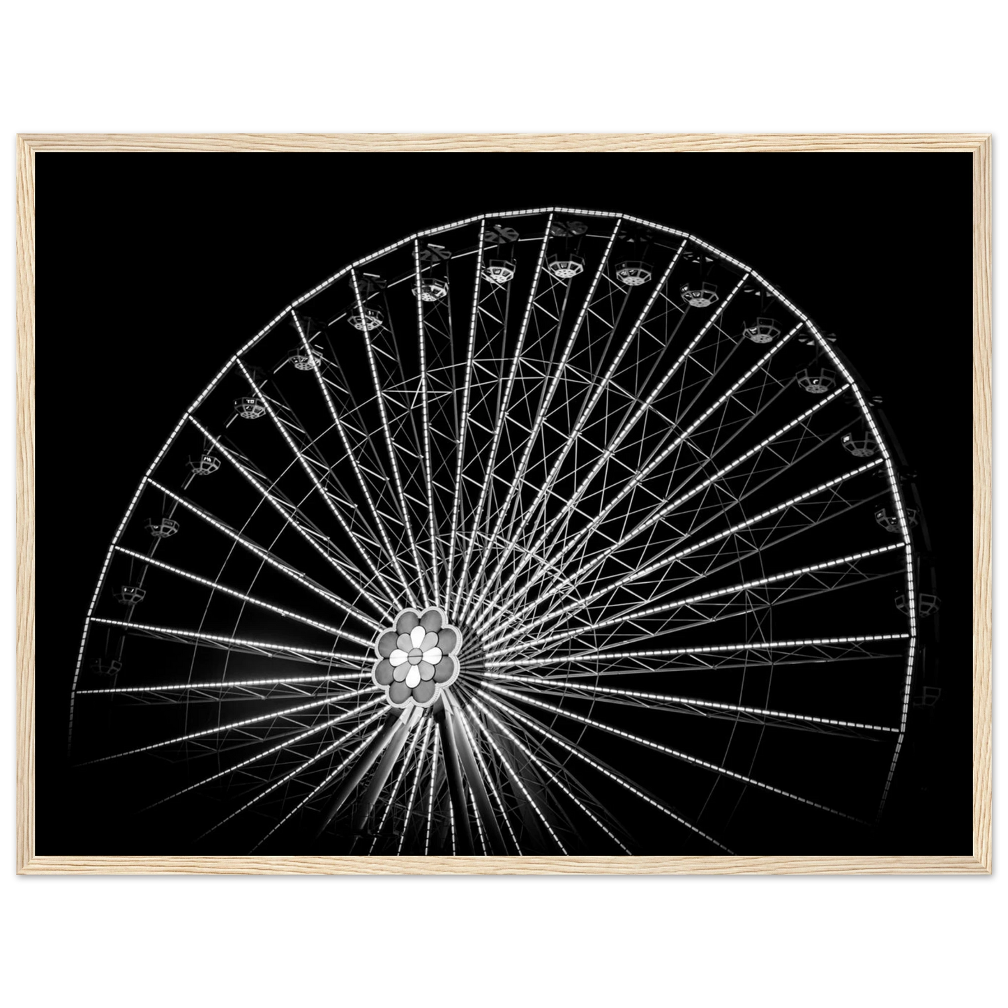 Black and white night photo of the Vienna Prater Giant Ferris Wheel (Wiener Riesenrad) with illuminated spokes forming a circular pattern against the dark sky on wooden framed wall art