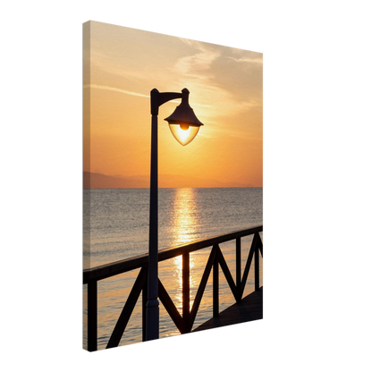 Canvas print wall art of a sunset over the sea with a street lamp on the pier