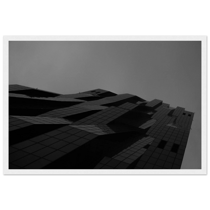 Black and white low angle view of a modern skyscraper with bold geometric lines and dark textured facade on wooden framed wall art