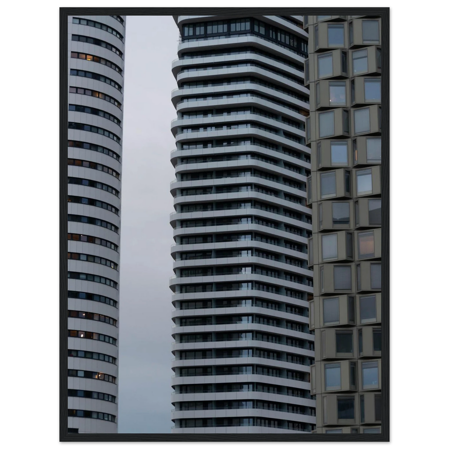 Modern high rise tower buildings with glass and steel facade reaching into the sky on wodden framed wall art