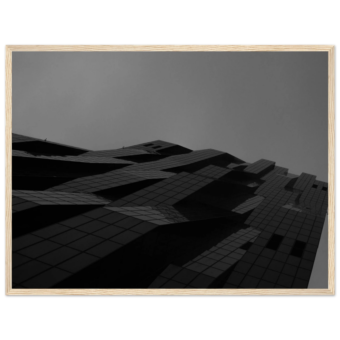 Black and white low angle view of a modern skyscraper with bold geometric lines and dark textured facade on wooden framed wall art