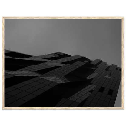 Black and white low angle view of a modern skyscraper with bold geometric lines and dark textured facade on wooden framed wall art