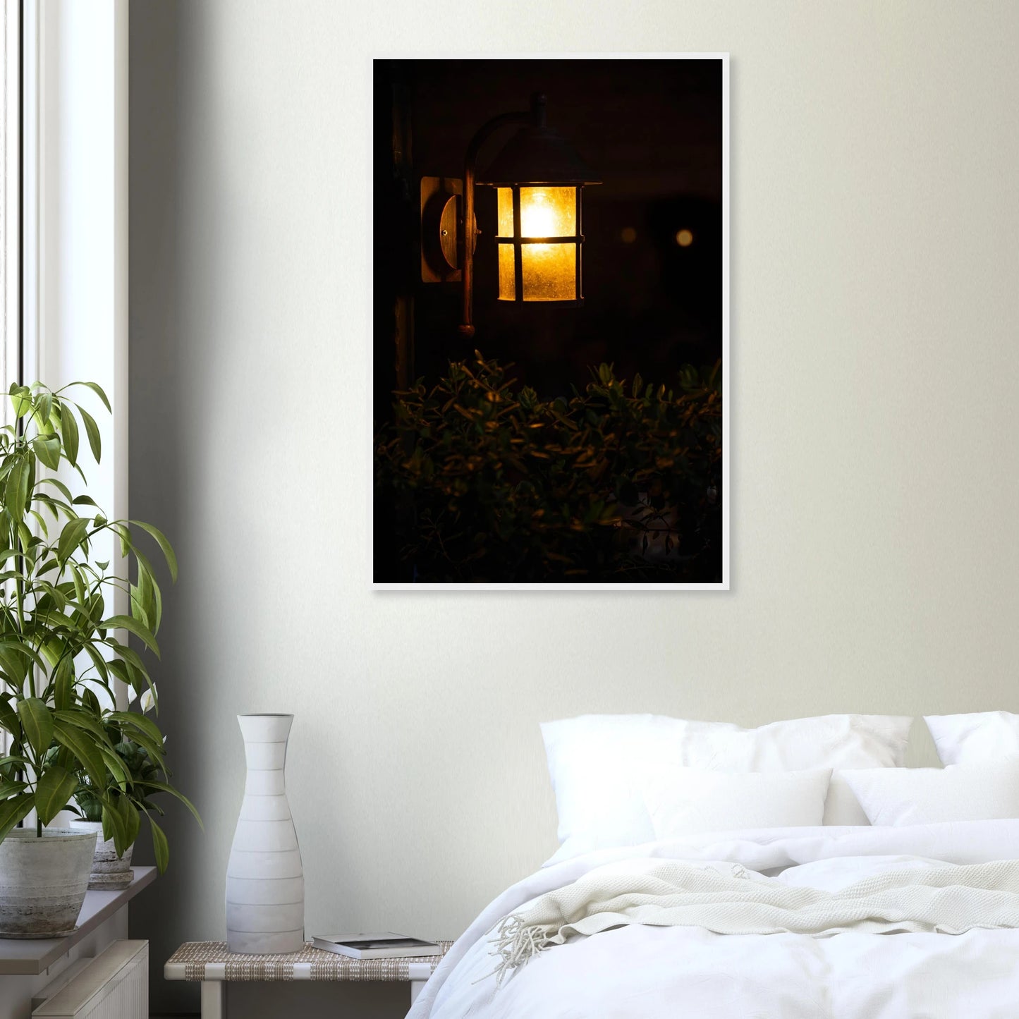 Glowing vintage lantern mounted on a wooden pole in front of a bush at night on wooden framed wall art on the wall in the Bedroom