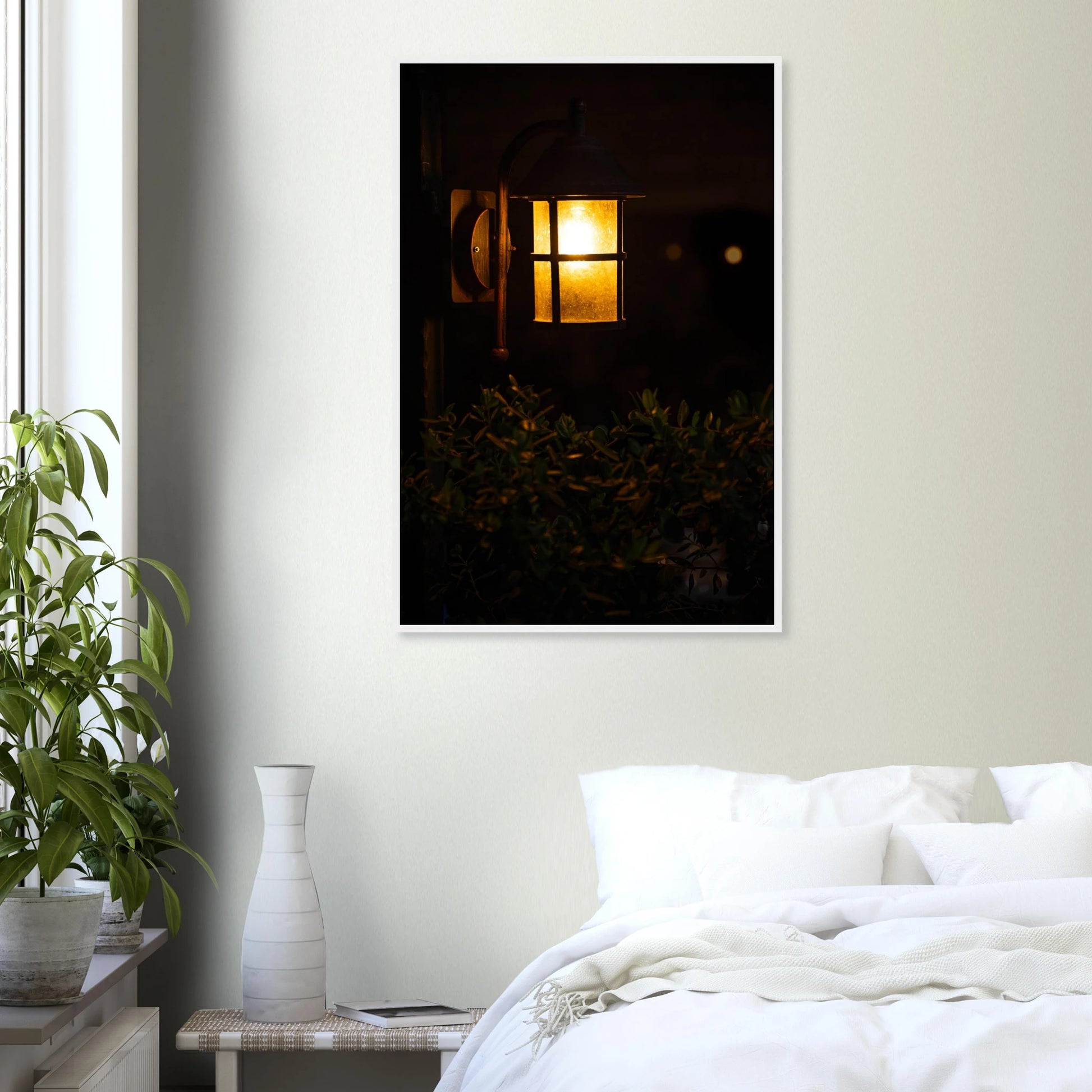 Glowing vintage lantern mounted on a wooden pole in front of a bush at night on wooden framed wall art on the wall in the Bedroom