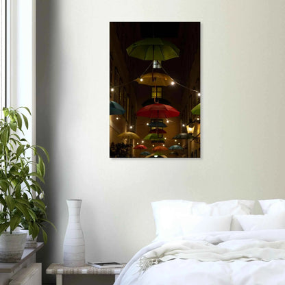 Nighttime street scene with colorful illuminated umbrellas hanging as decoration above a vibrant outdoor area on a Canvas print wall art on the wall in the Bedroom